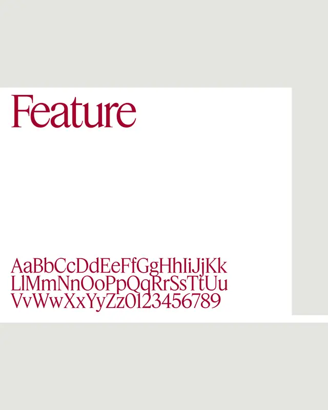 The second type specimen: Feature set in itself, above the full alphabet and figures, crimson on a white card.